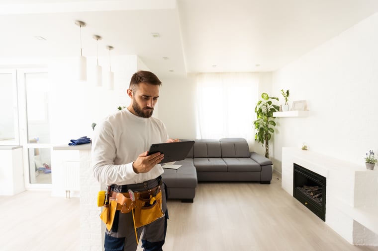 residential contractor holding a tablet 